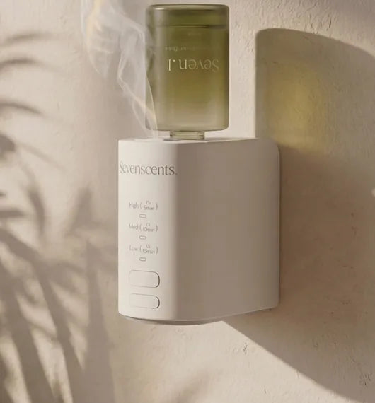 The Spirit diffuser plugged into a wall in a sunlit room